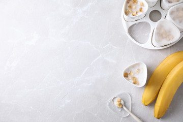 Flat lay composition with cups of banana yogurt on table, space for text. Multi cooker recipe