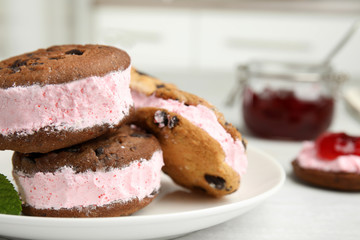Sweet delicious ice cream cookie sandwiches on plate, closeup. Space for text