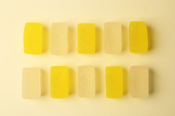Assorted tasty jelly candies on color background, flat lay