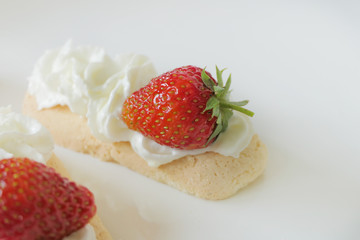 Biscuits with Cream and Strawberries isolated on a White Background