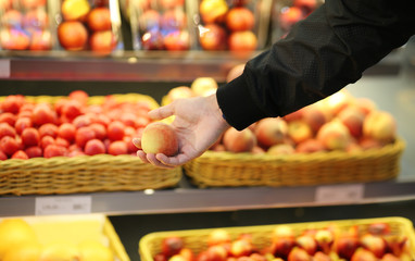 Young man buying fruits at the market