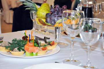 festive table, beautifully served canapes with salmon, fruit.