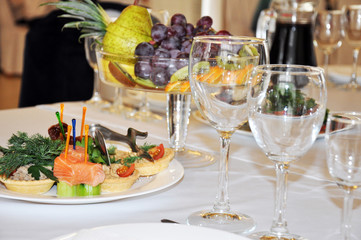 festive table, beautifully served canapes with salmon, fruit.