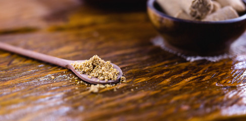 Paçoca ground in a wooden spoon, typical Brazilian peanut candy. Food from Brazil made in the northeast and in the state of Minas Gerais.