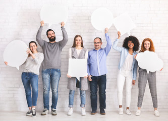 Group of diverse people holding blank speech bubbles