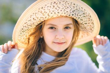 portrait of a young  girl with a hat on sunny day