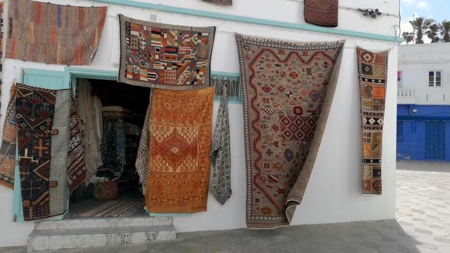 Moroccan carpets hanging on the facades - Asilah, Morocco