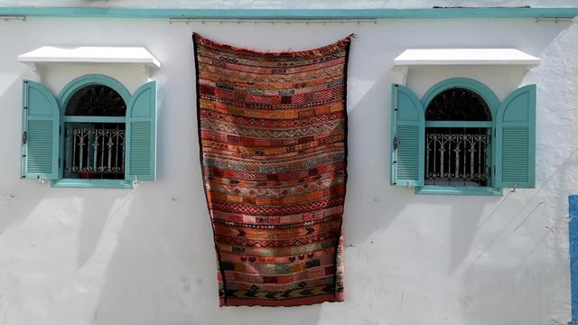 Moroccan carpets hanging on the facades - Asilah, Morocco