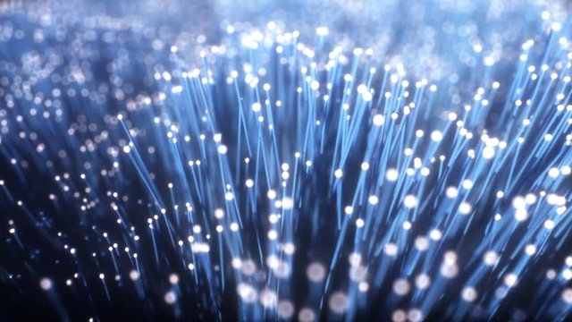 Millions of fiber optic cables with light movement, camera moves along wires transmitting data signal in blue color. Seamless loop 4k animation