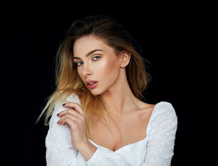 Portrait of sexy blonde woman looking at camera and  isolated on black background