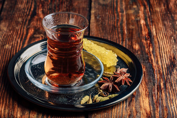 Spiced tea in armudu with crystal sugar