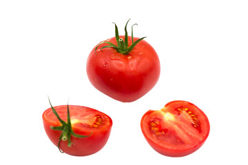 ripe fresh organic tomato and two halves of a tomato in the drops of dew isolated on a white background