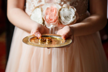 Golden wedding rings for newlyweds on their wedding day