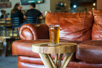 pint of beer at brewery in front of comfortable sofa