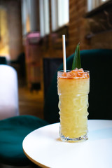 tiki drink in tiki glass at bar