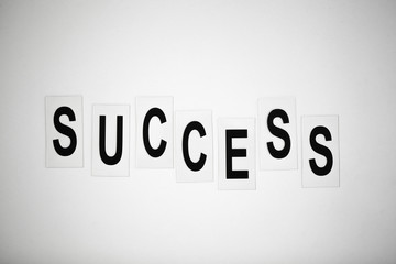 Success word written on white table. Copy space