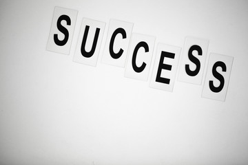 Success word written on white table. Copy space