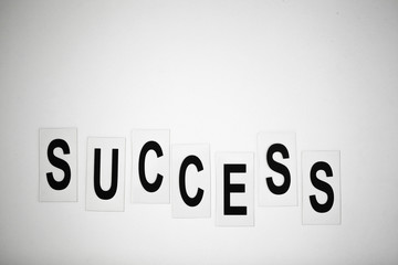 Success word written on white table. Copy space