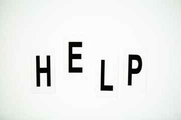 HELP word written on white table. Copy space