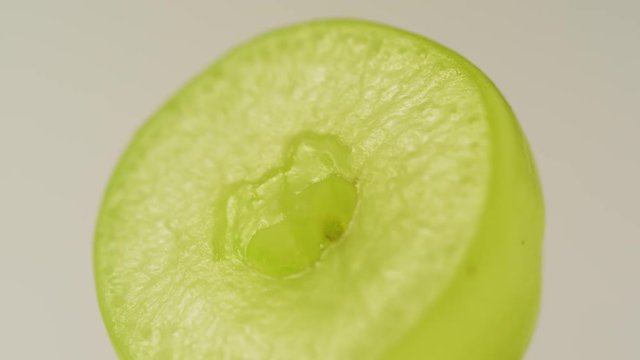 Half of a juicy grape on white background