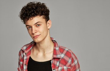 Natural handsome man in shirt smiling and looking at camera