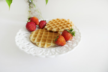 Waffles with Strawberries in a Plate isolated on a White Background