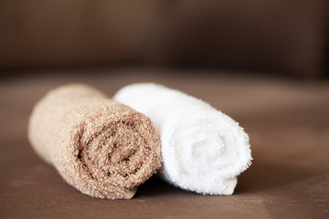 Fototapeta na wymiar Chocolate Spa . Composition brown towel in hotel room of spa treatment