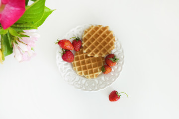 Waffles with Strawberries in a Plate isolated on a White Background
