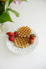 Waffles with Strawberries in a Plate isolated on a White Background