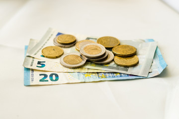Euro banknotes and coins on the table