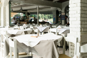 Tables and chairs in the restaurant on open terse by the seaside white
