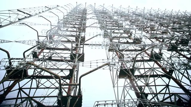 Close-up detail view of large telecommunication antenna tower in Chernobyl power plant courtyard. Scene of abandoned closed atomic station radio center Duga during a summer tour.