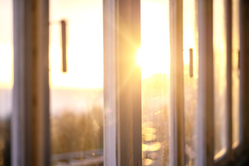 View of the evening sunset through a closed window - Powered by Adobe