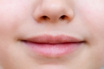 Part of face,young woman close up. Plump lips without makeup