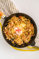 melted cheese in a pan with wpaghetti pasta and seafood top view