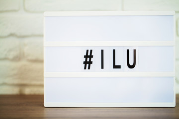 Led letter board with hashtag word on table.