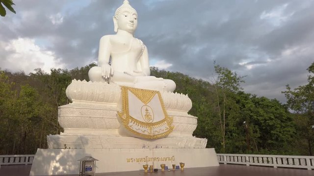 Slow camera upward tilt of the Wat Phra That Mae Yen big Buddha located in Pai, Thailand.