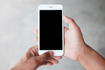 Cropped shot view of man hands holding smart phone with blank copy space screen for your text message or information content, female reading text message on cell telephone during in urban setting. 