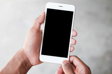Cropped shot view of man hands holding smart phone with blank copy space screen for your text message or information content, female reading text message on cell telephone during in urban setting. 