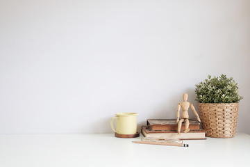 Mockup workspace desk and copy space books,plant and coffee on white desk.