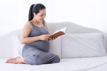 Pregnant woman reading a book.