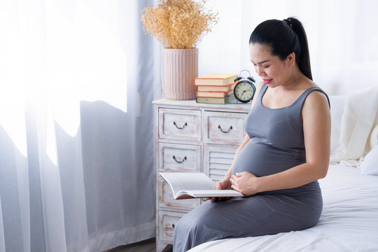 Pregnant woman reading a book. Mental health care and pregnancy.