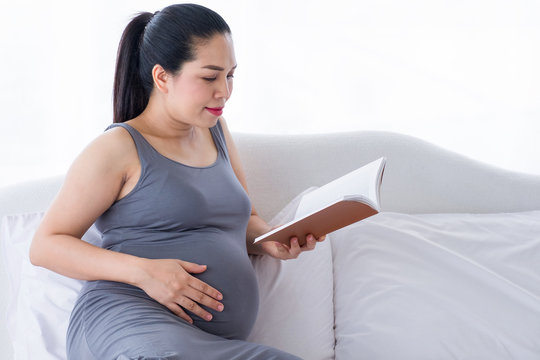 Pregnant woman reading a book.