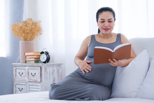 Pregnant woman reading a book.