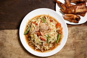 Spicy papaya salad and grilled chicken wing, Thai food (Som Tum)