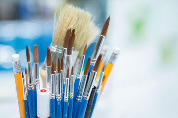 Many brushes and art supplies