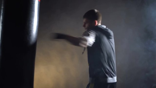 Boxer training in the gym on a dark background