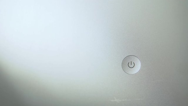 Finger press power button to turn on computer.