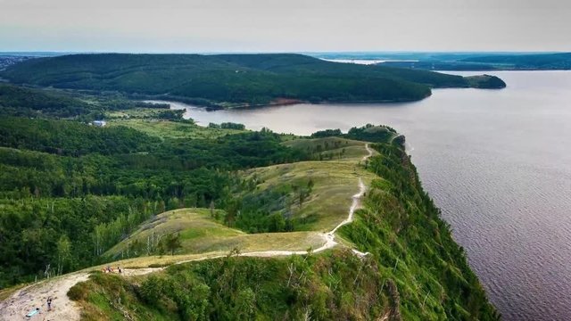 Aerial view of Zhiguli mountains with green trees and Volga river in Samarskaya Luka national park during summer evening, Samara region, Russia