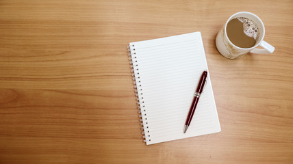 cup of coffee and notebook on a table